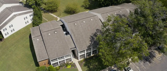 an aerial view of a house with a yard and lake view
