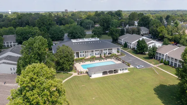 an aerial view of a house with swimming pool and garden