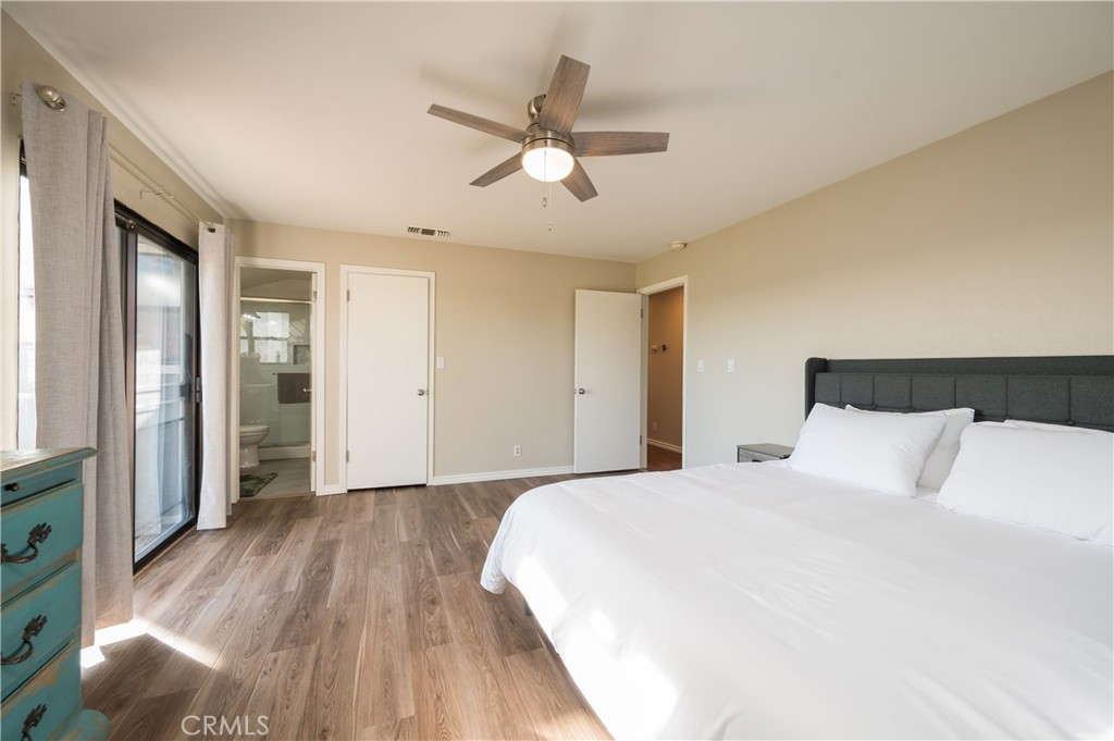 5175 White Tail Place Paso Robles, CA 93446 - Photo 14 of 37 a bedroom with a large bed and a chandelier