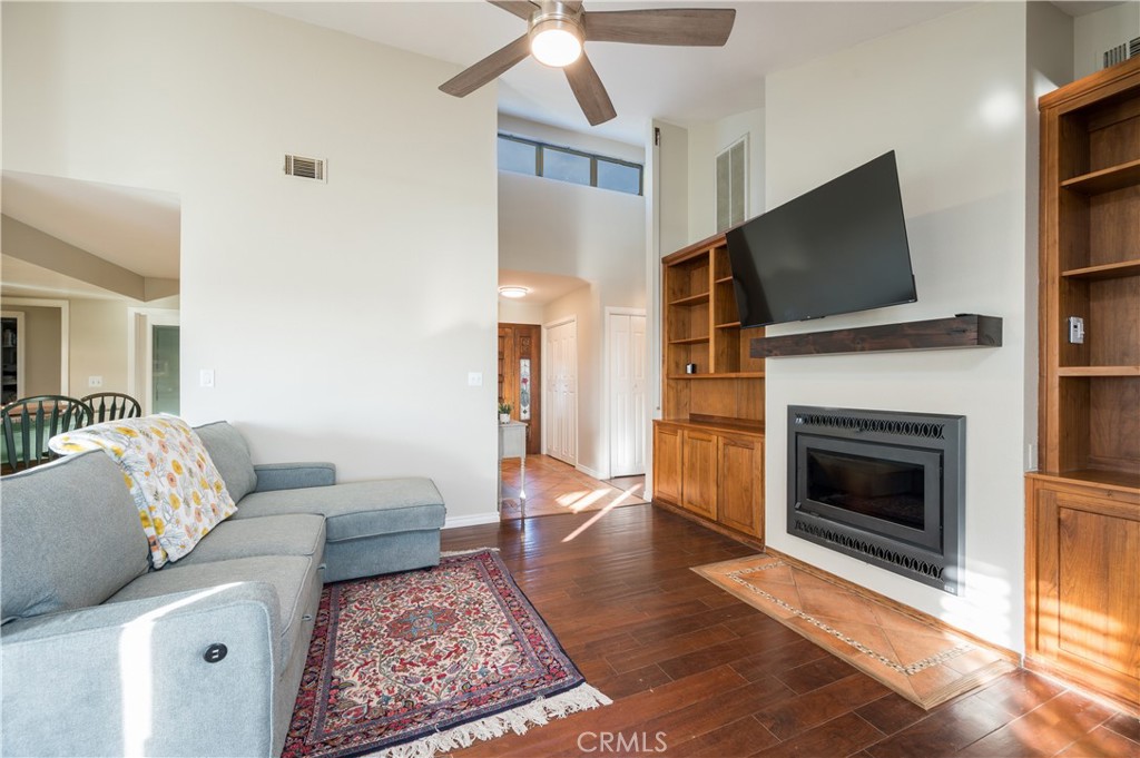5175 White Tail Place Paso Robles, CA 93446 - Photo 7 of 37 a living room with furniture a flat screen tv and a fireplace