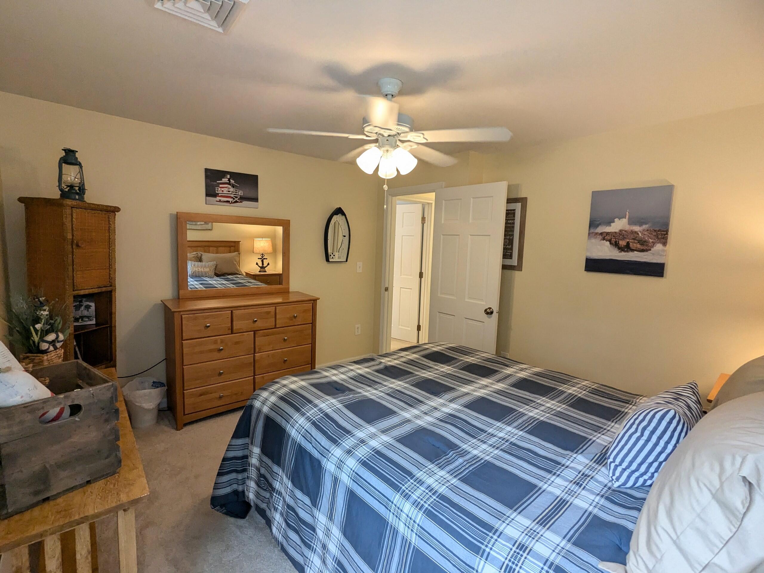 32 Apple Lane Dennis, MA 02638 - Photo 33 of 48 a bedroom with a bed and a chandelier