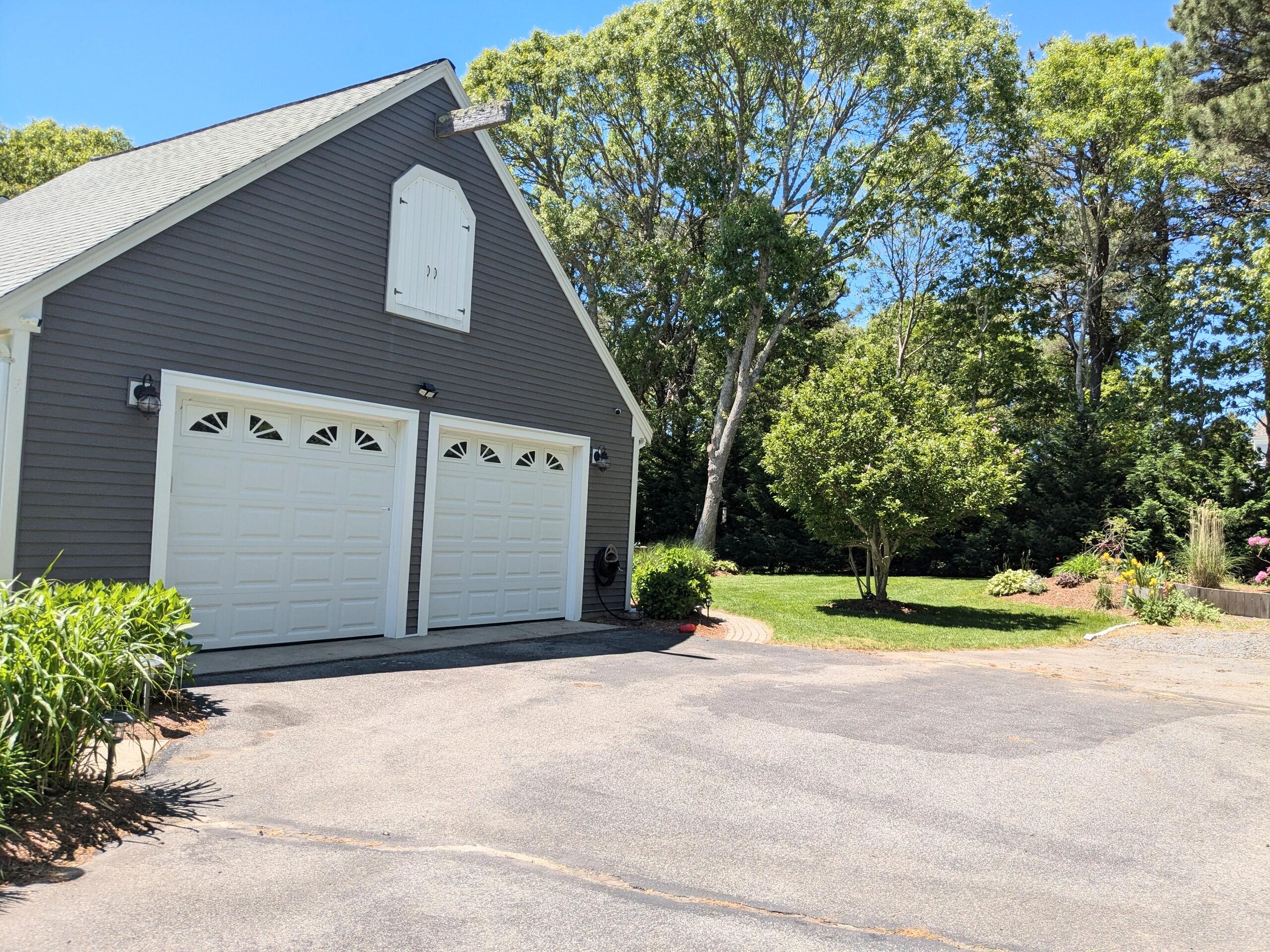 32 Apple Lane Dennis, MA 02638 - Photo 44 of 48 a front view of a house with a yard and garage