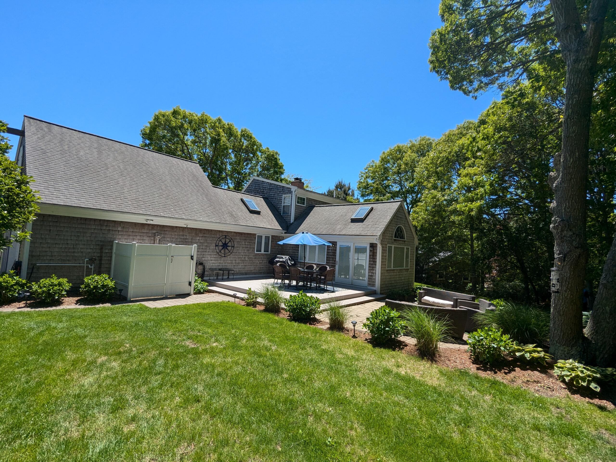 32 Apple Lane Dennis, MA 02638 - Photo 46 of 48 a view of a house with a yard porch and sitting area