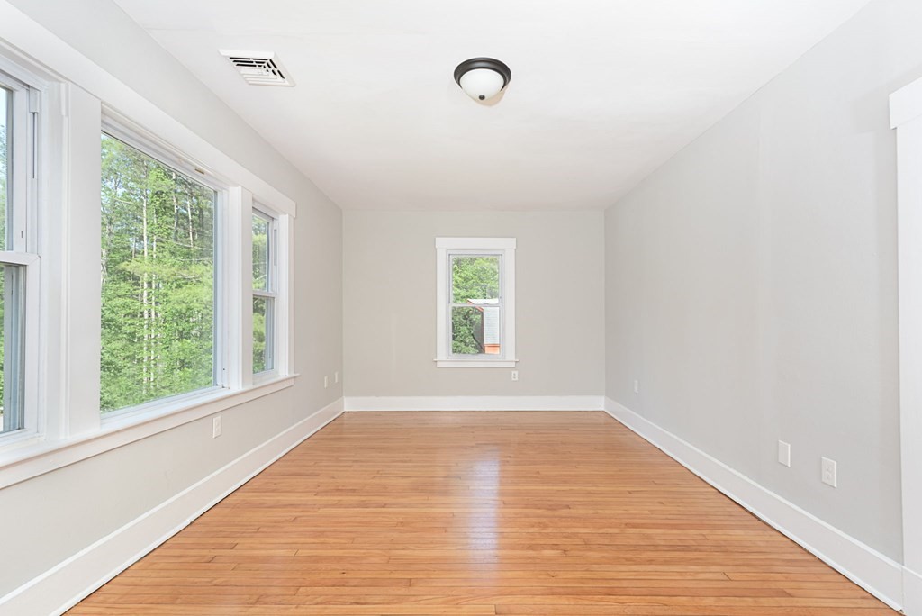 230 Southbridge Road Charlton, MA 01507 - Photo 13 of 35 a view of an empty room with wooden floor and a window