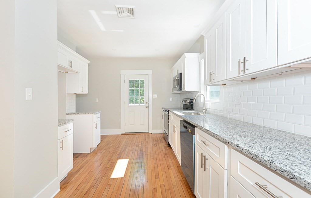 230 Southbridge Road Charlton, MA 01507 - Photo 18 of 35 a kitchen with granite countertop white cabinets and white appliances