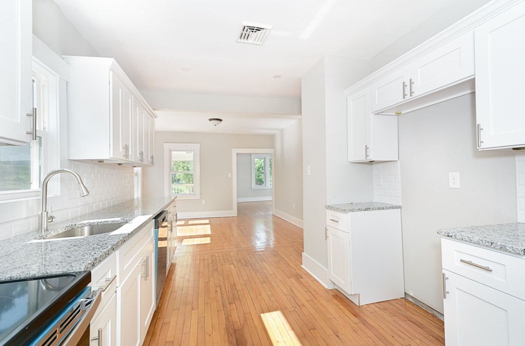 230 Southbridge Road Charlton, MA 01507 - Photo 20 of 35 a kitchen with granite countertop a sink stove and refrigerator