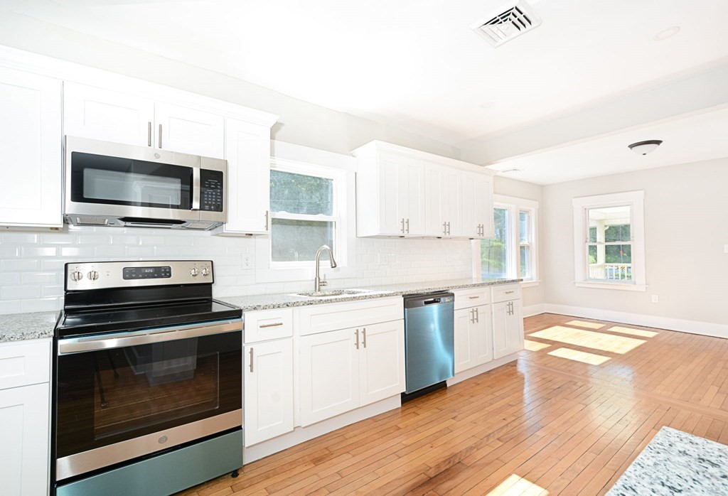 230 Southbridge Road Charlton, MA 01507 - Photo 21 of 35 a kitchen with a stove and a microwave