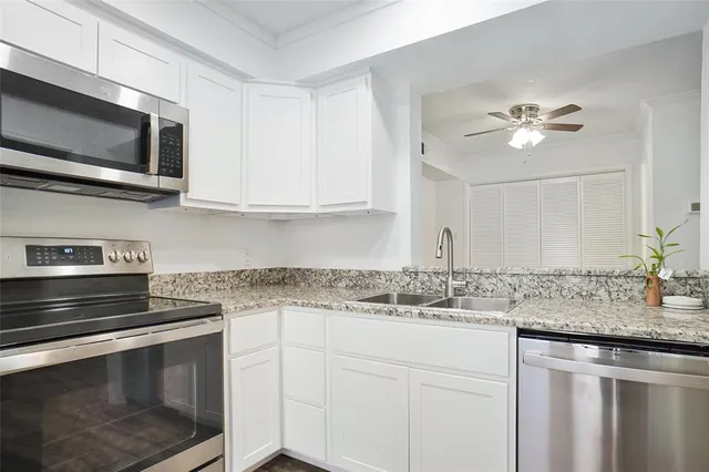 a kitchen with stainless steel appliances granite countertop a stove a microwave and cabinets