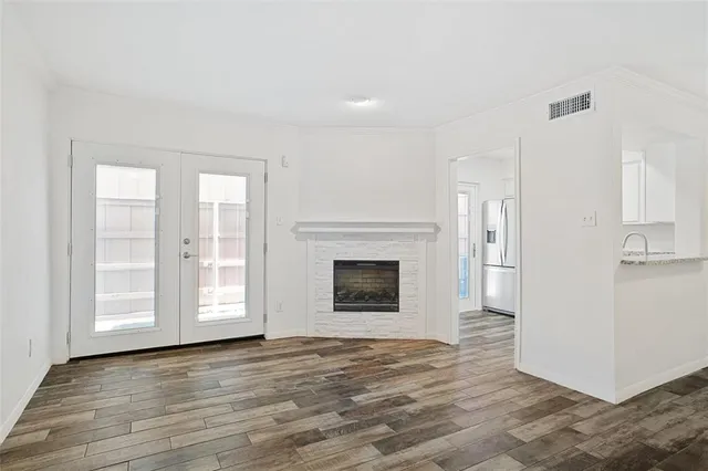 a view of a livingroom with an empty space and a fireplace