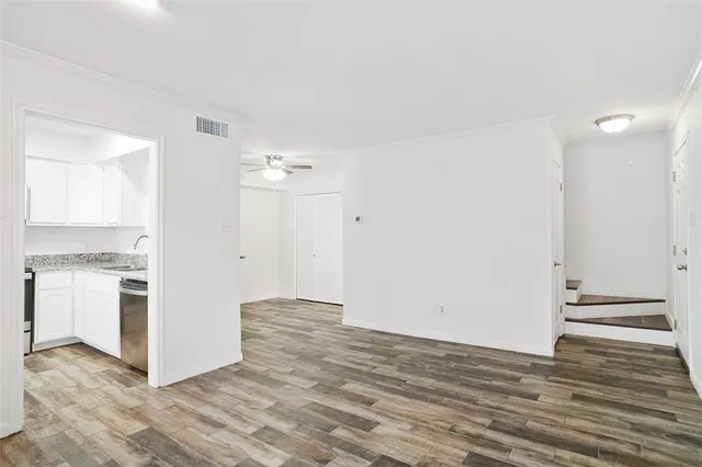 a view of a kitchen with wooden floor and a sink