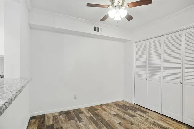 a view of room with window and ceiling fan