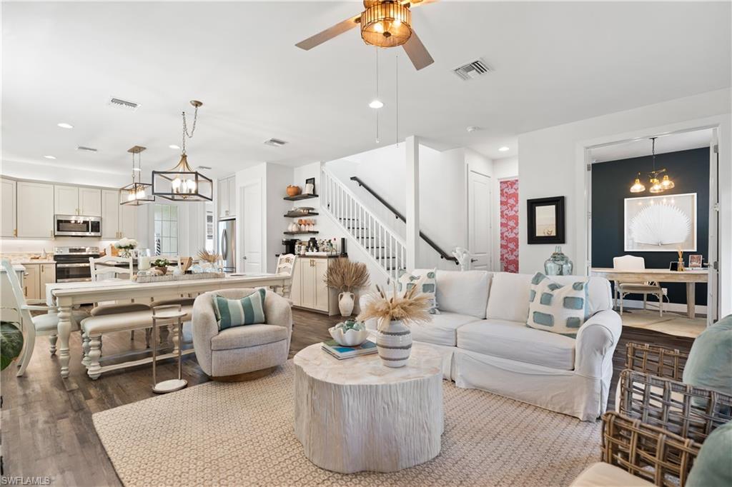 3060 Woodside Avenue Naples, FL 34112 - Photo 35 of 36 a living room with furniture kitchen view and a chandelier