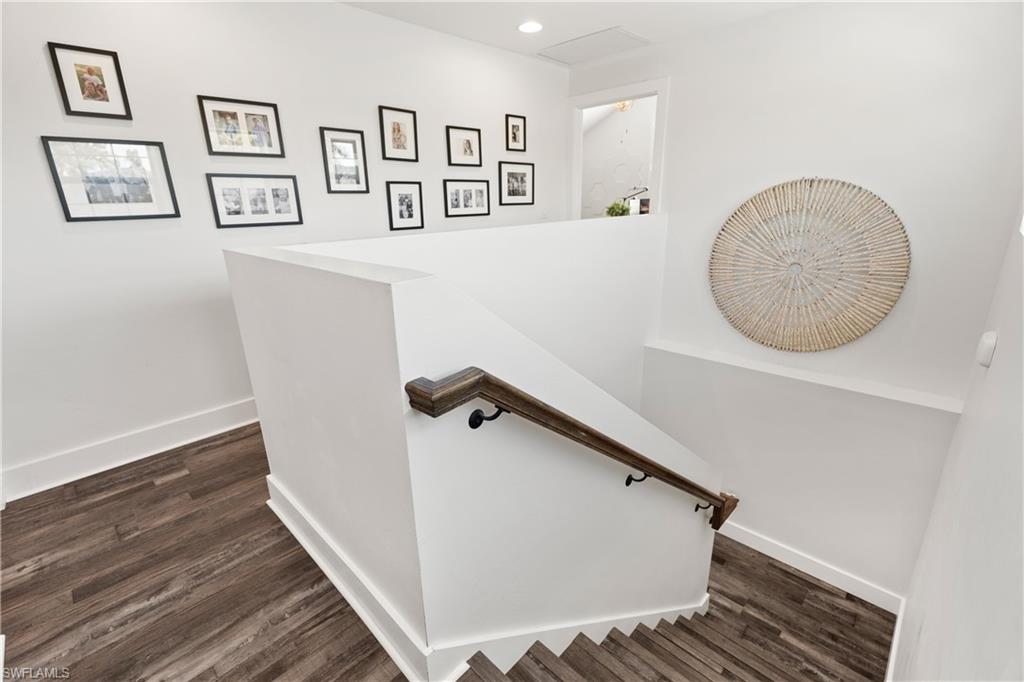 3060 Woodside Avenue Naples, FL 34112 - Photo 17 of 36 a view of a hallway with paintings on the wall