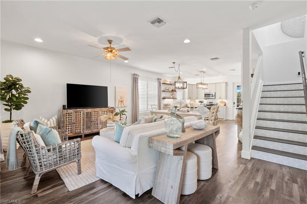 3060 Woodside Avenue Naples, FL 34112 - Photo 1 of 36 a living room with furniture a flat screen tv and a view of kitchen