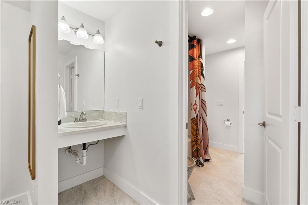 3060 Woodside Avenue Naples, FL 34112 - Photo 20 of 36 a view of a kitchen from the hallway