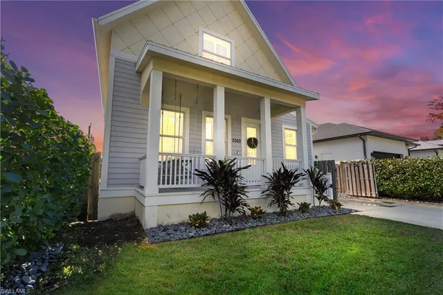 a view of a house with backyard and a garden