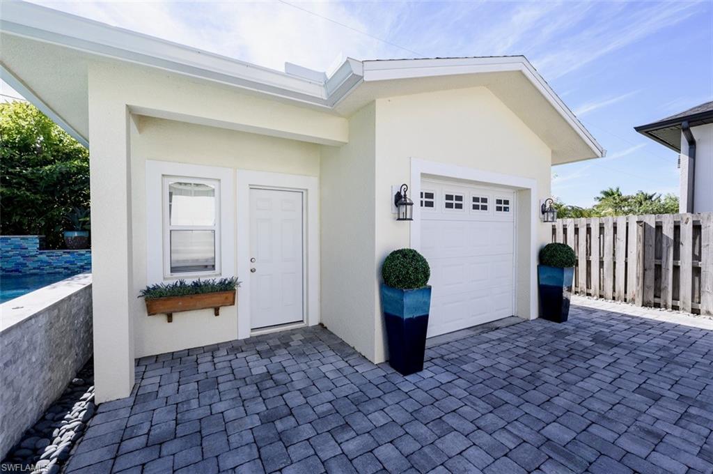 3060 Woodside Avenue Naples, FL 34112 - Photo 31 of 36 a outdoor space with sliding door and wooden floor