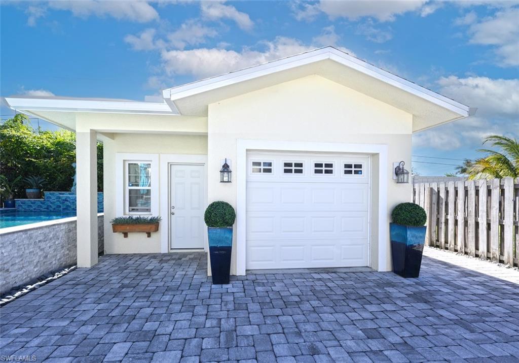 3060 Woodside Avenue Naples, FL 34112 - Photo 32 of 36 a front view of a house with a yard