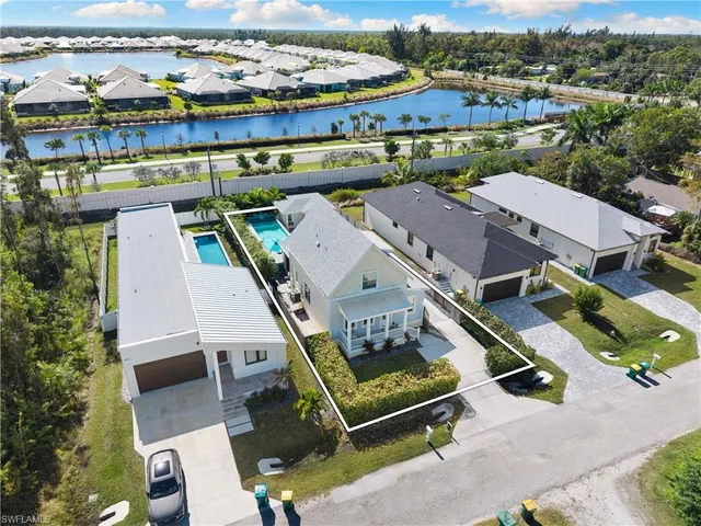 an aerial view of residential houses with outdoor space and trees