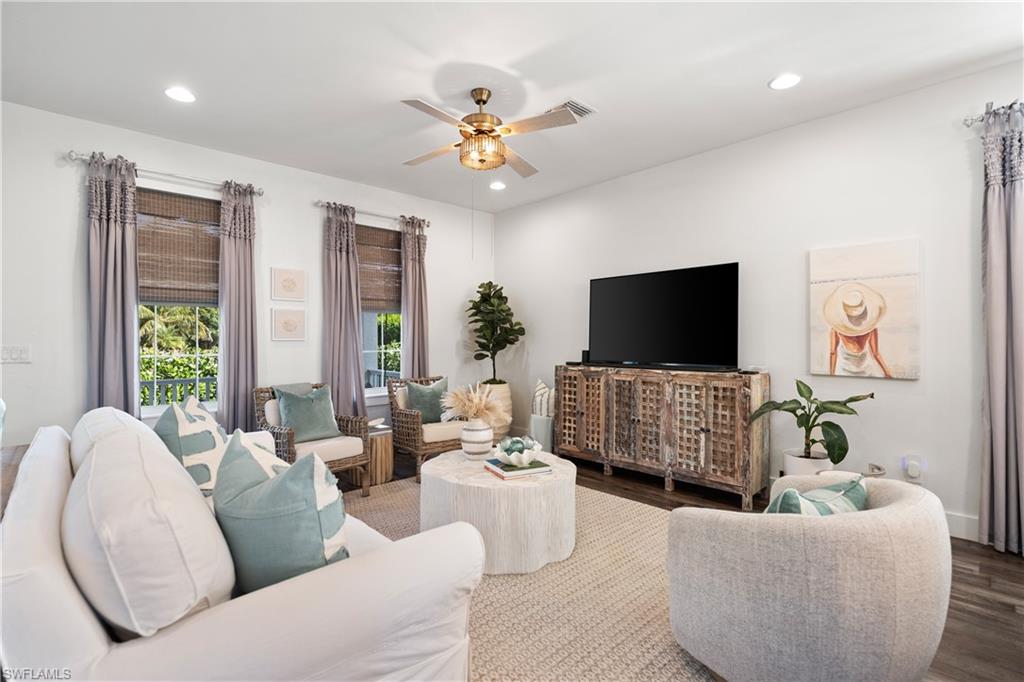 3060 Woodside Avenue Naples, FL 34112 - Photo 36 of 36 a living room with furniture and a flat screen tv
