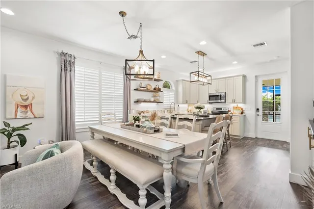 a kitchen with stainless steel appliances kitchen island granite countertop a stove a sink and a refrigerator