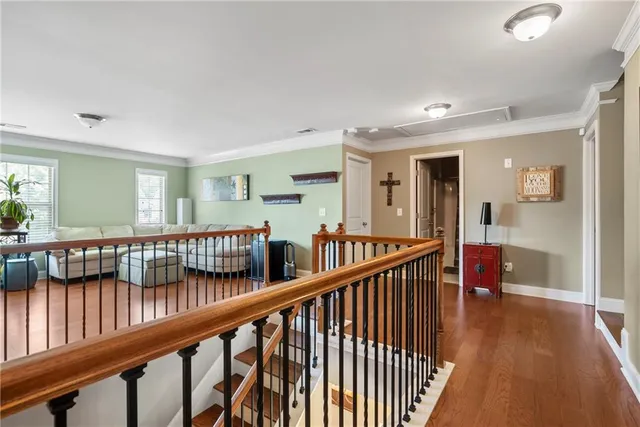 a view of staircase with railing and a rug