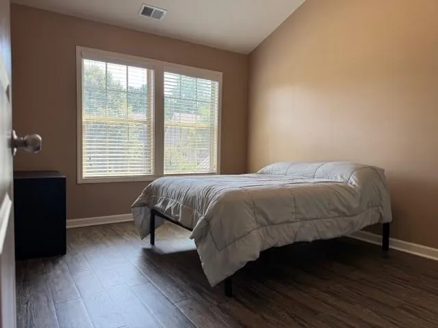 a bedroom with a bed and a window