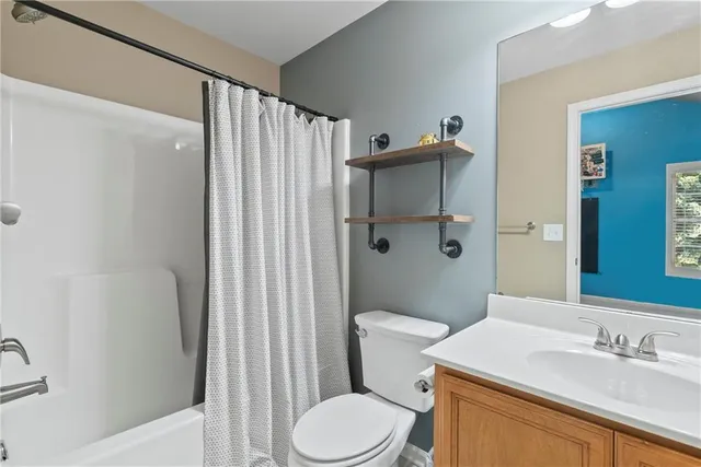 a white toilet sitting next to a bathroom sink