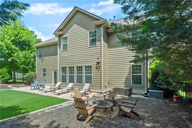 a backyard of a house with outdoor seating