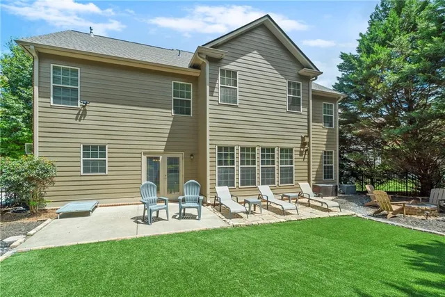a front view of house with a garden and patio