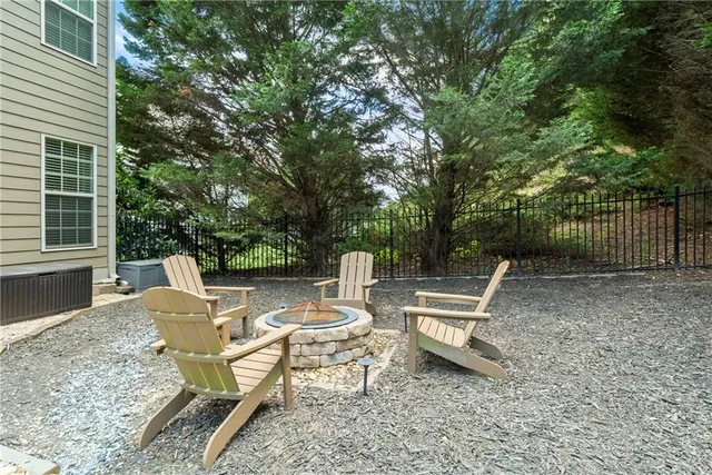 a view of a chair and table in the backyard