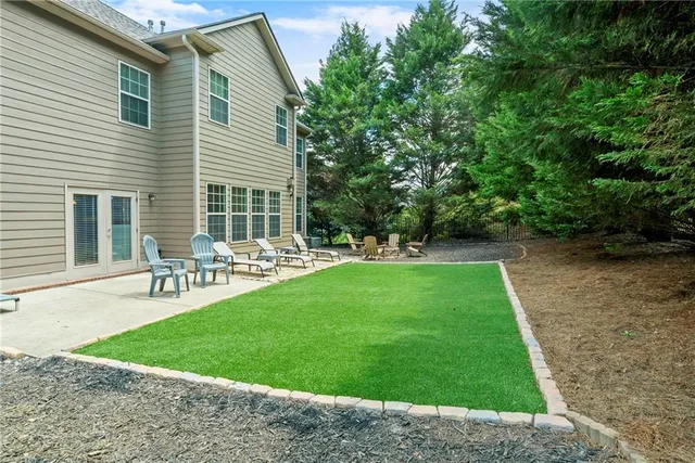 a view of a patio with table and chairs and potted plants