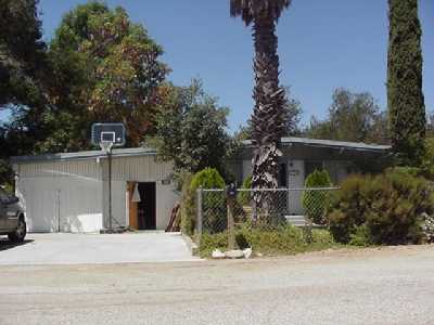 309 Riverside Road Oak View, CA 93022 - Photo 1 of 1 a front view of a house with a yard and garage