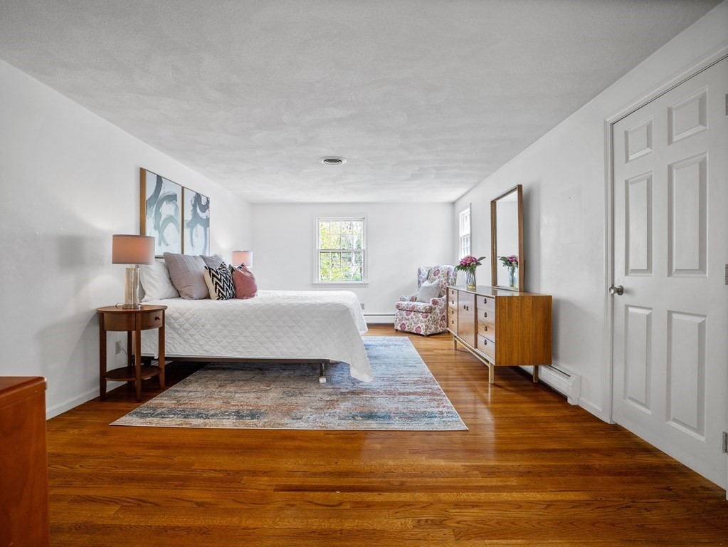 110 Glen Road Wellesley, MA 02481 - Photo 13 of 22 a spacious bedroom with a bed and a couch