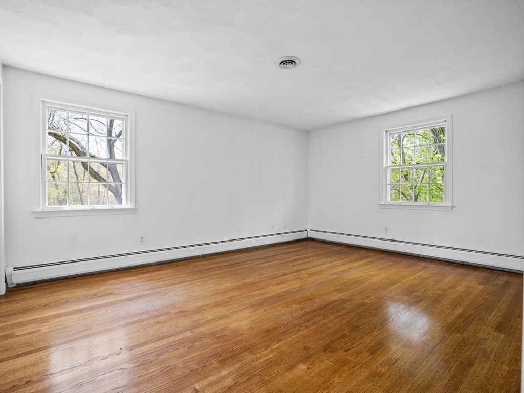 110 Glen Road Wellesley, MA 02481 - Photo 16 of 22 a view of an empty room with wooden floor and a window