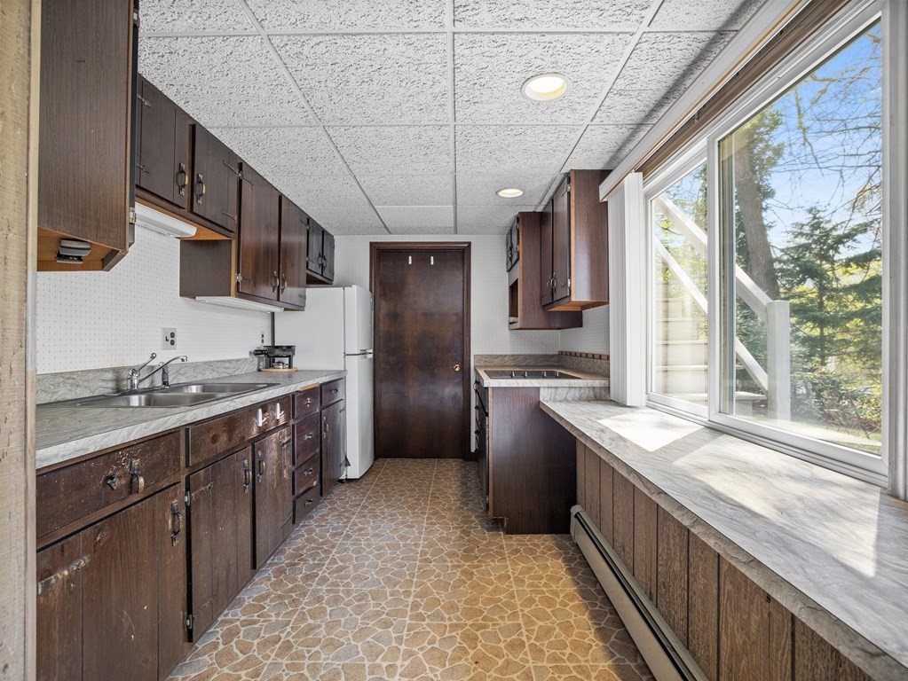 110 Glen Road Wellesley, MA 02481 - Photo 18 of 22 a kitchen with stainless steel appliances granite countertop a sink stove and refrigerator