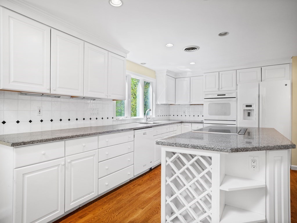 110 Glen Road Wellesley, MA 02481 - Photo 8 of 22 a kitchen with granite countertop white cabinets and white stainless steel appliances