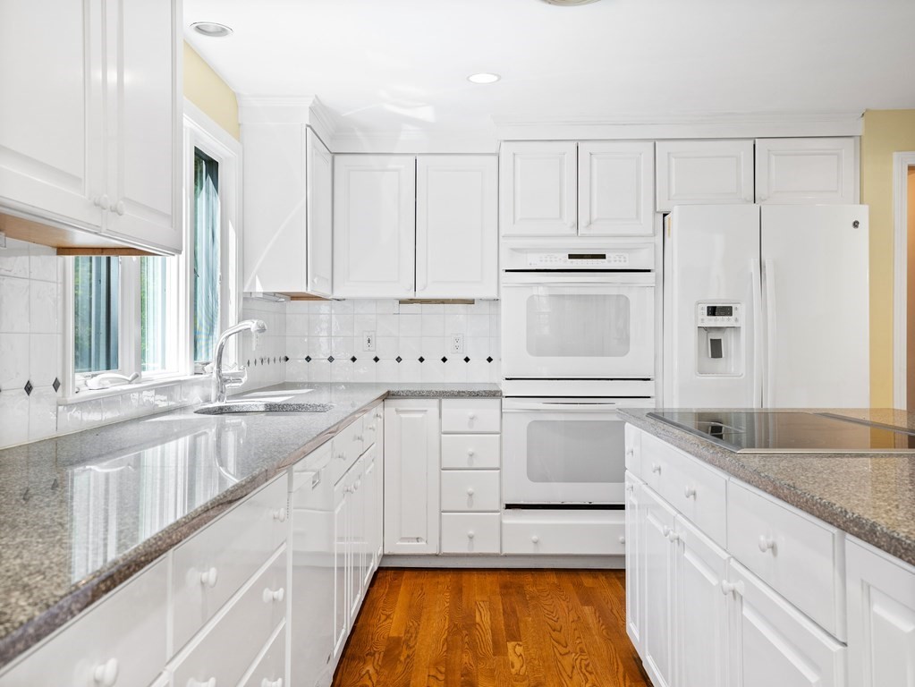 110 Glen Road Wellesley, MA 02481 - Photo 9 of 22 a kitchen with granite countertop white cabinets and white appliances