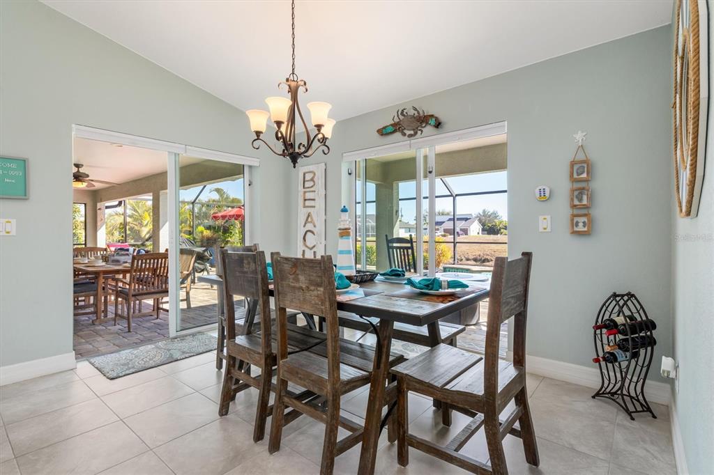 259 Marker Road Rotonda West, FL 33947 - Photo 12 of 37 a view of a dining room with furniture and chandelier