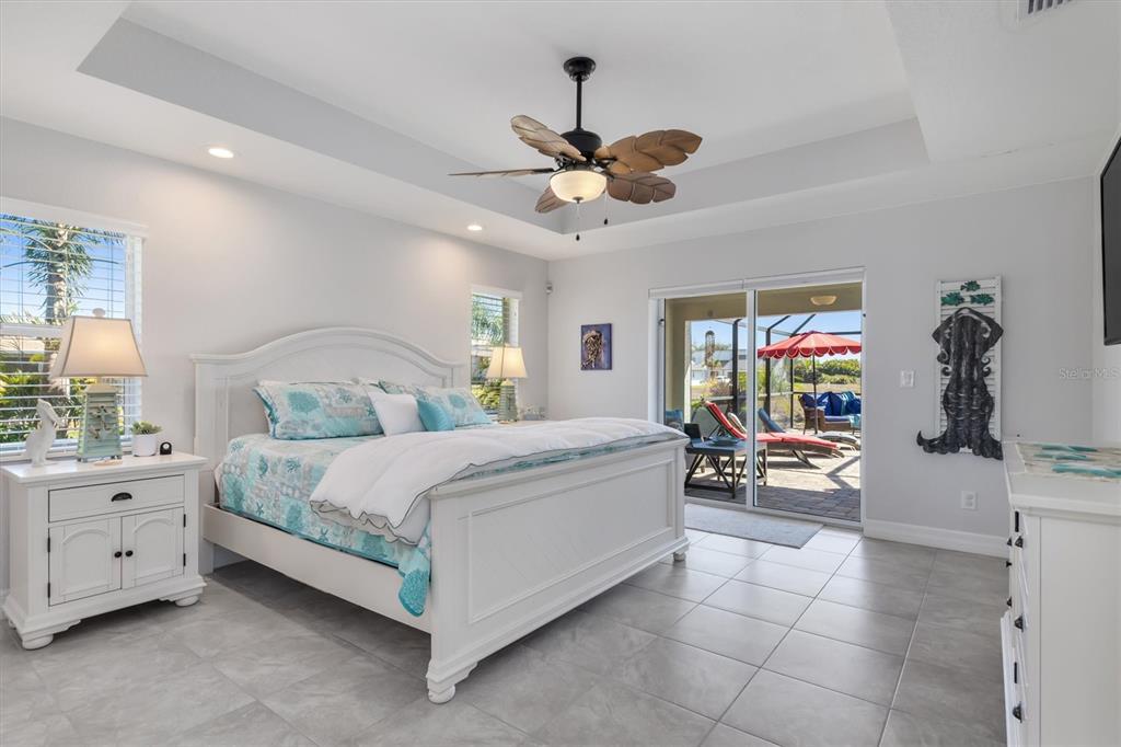 259 Marker Road Rotonda West, FL 33947 - Photo 13 of 37 a bedroom with a bed and a chandelier
