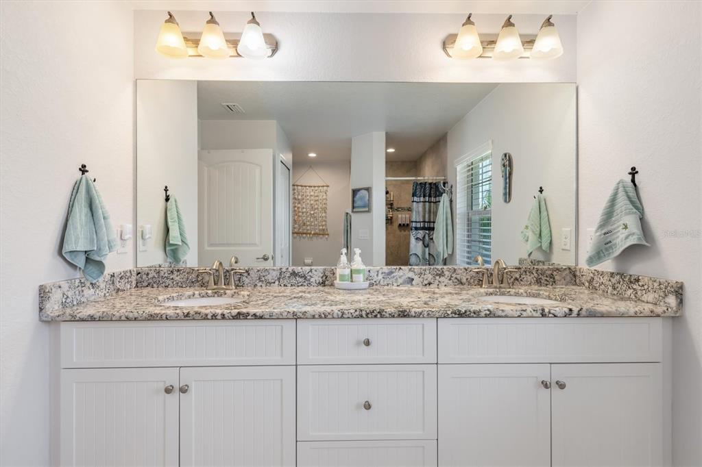 259 Marker Road Rotonda West, FL 33947 - Photo 16 of 37 a bathroom with a granite countertop sink and a mirror