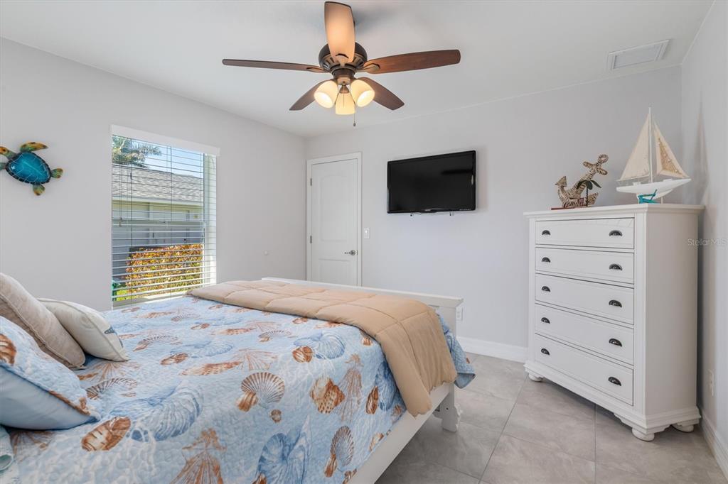 259 Marker Road Rotonda West, FL 33947 - Photo 20 of 37 a bedroom with a bed and a tv