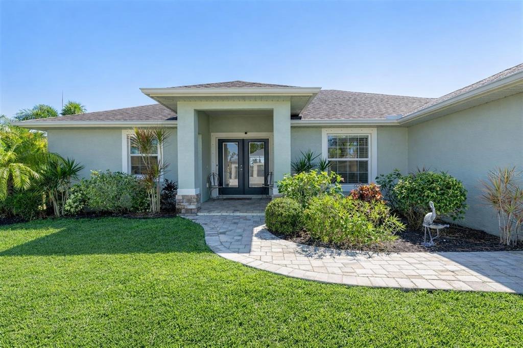 259 Marker Road Rotonda West, FL 33947 - Photo 2 of 37 a front view of a house with a garden