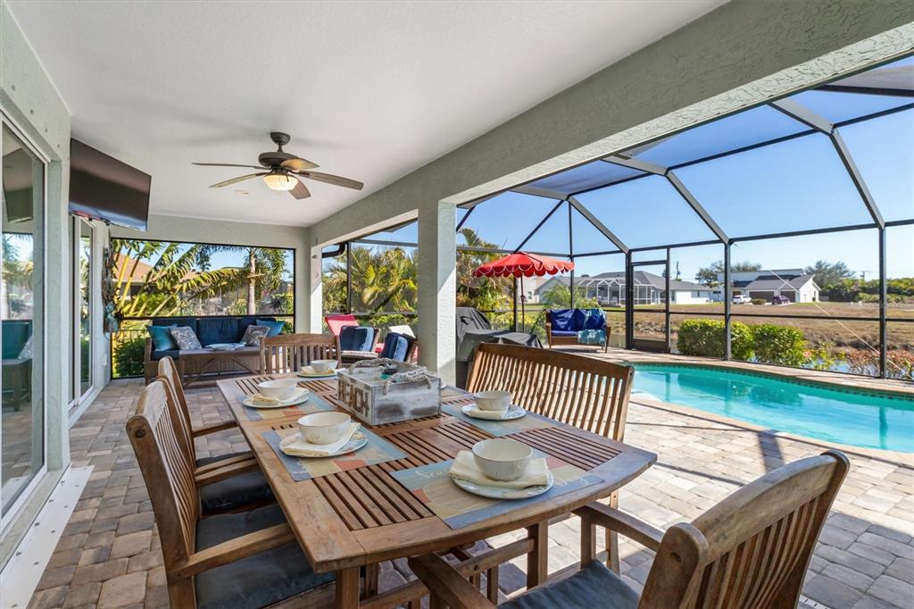 259 Marker Road Rotonda West, FL 33947 - Photo 23 of 37 a view of a patio with a dining table and chairs