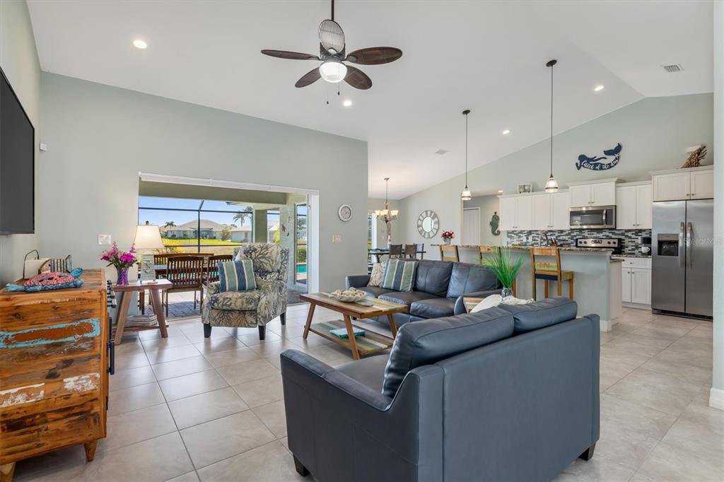 259 Marker Road Rotonda West, FL 33947 - Photo 5 of 37 a living room with furniture kitchen view and a chandelier