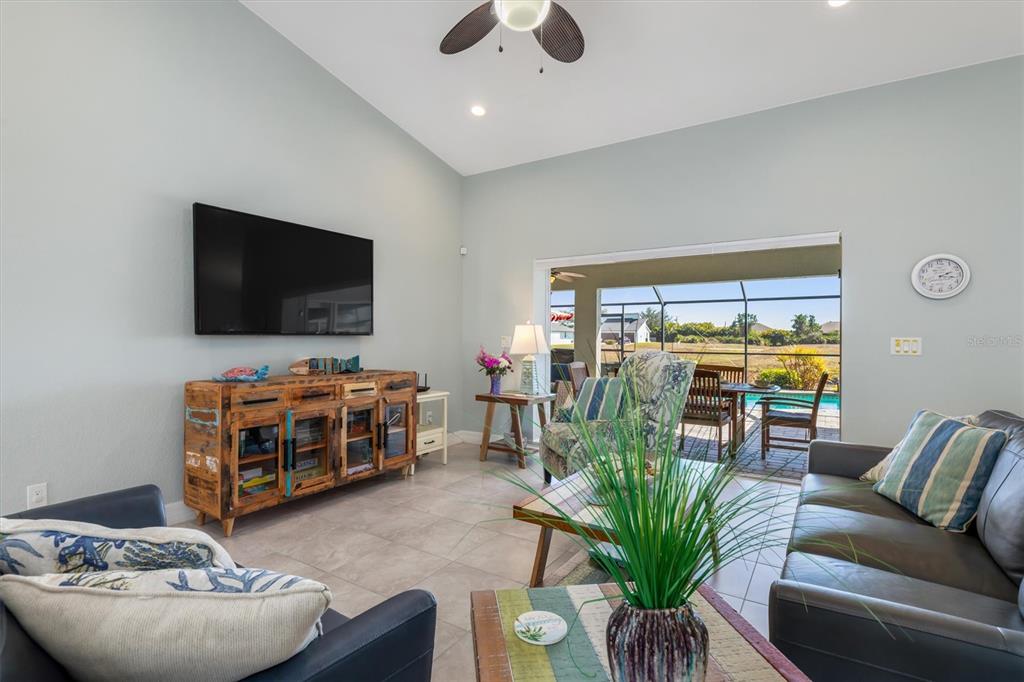 259 Marker Road Rotonda West, FL 33947 - Photo 6 of 37 a living room with furniture and a flat screen tv