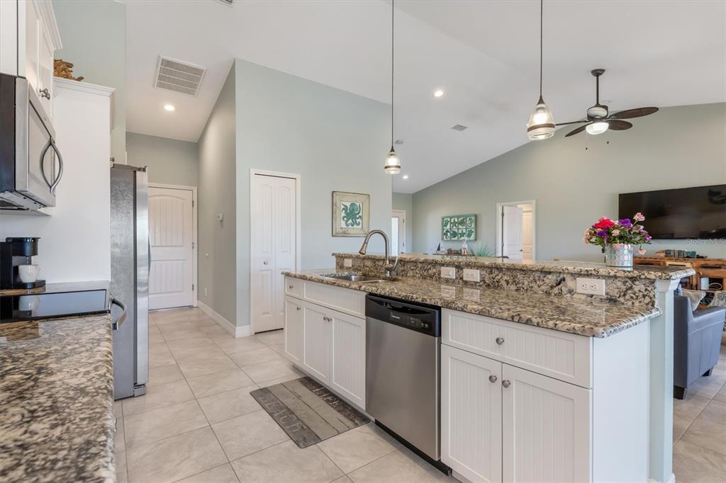 259 Marker Road Rotonda West, FL 33947 - Photo 10 of 37 a kitchen with stainless steel appliances granite countertop a sink and a refrigerator