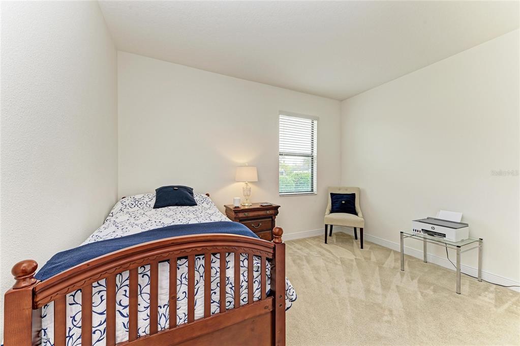 302 Cockle Shell Loop Apollo Beach, FL 33572 - Photo 49 of 75 a bedroom with furniture and a window