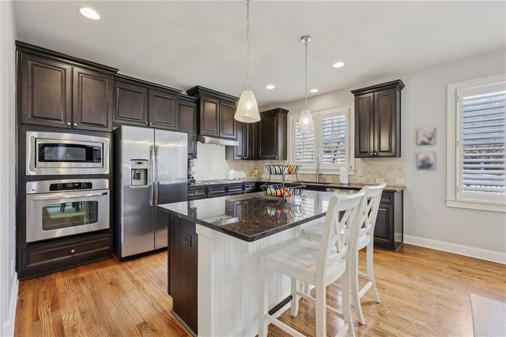 5775 Cascade Trail Cumming, GA 30040 - Photo 12 of 49 a kitchen with stainless steel appliances granite countertop a sink refrigerator and microwave