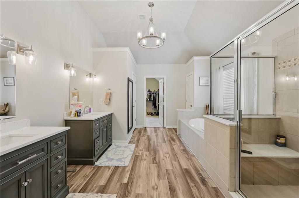 5775 Cascade Trail Cumming, GA 30040 - Photo 20 of 49 a large bathroom with a double vanity sink a mirror and a shower